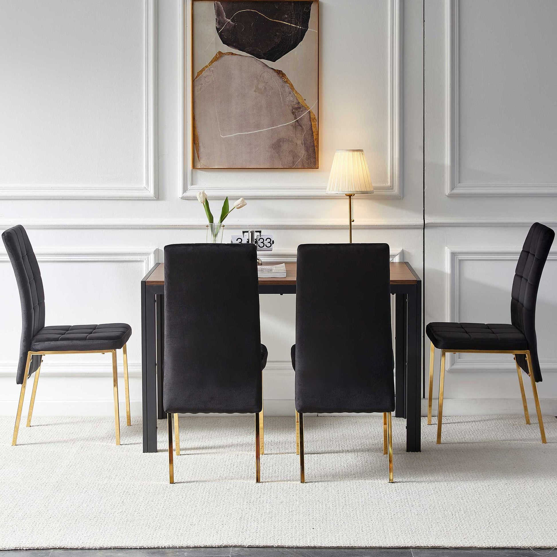 A modern dining room featuring a 5 Pieces Dining Set with velvet high back chairs, golden legs, and a creative dining table, complemented by abstract wall art and décor against white paneled walls and a light carpet.