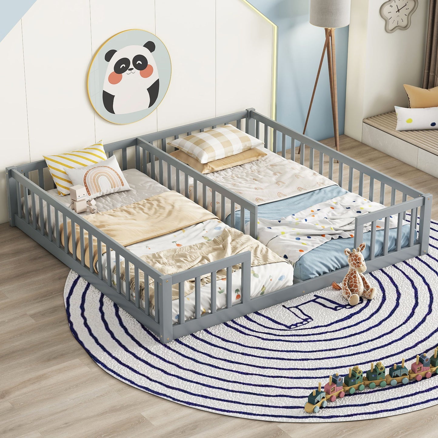 A children’s bedroom with a gray Double Floor Bed With Fence and guardrails (without door), pastel bedding, plush toys, a blue-and-white circular rug, panda wall art, and toy blocks scattered on the floor.