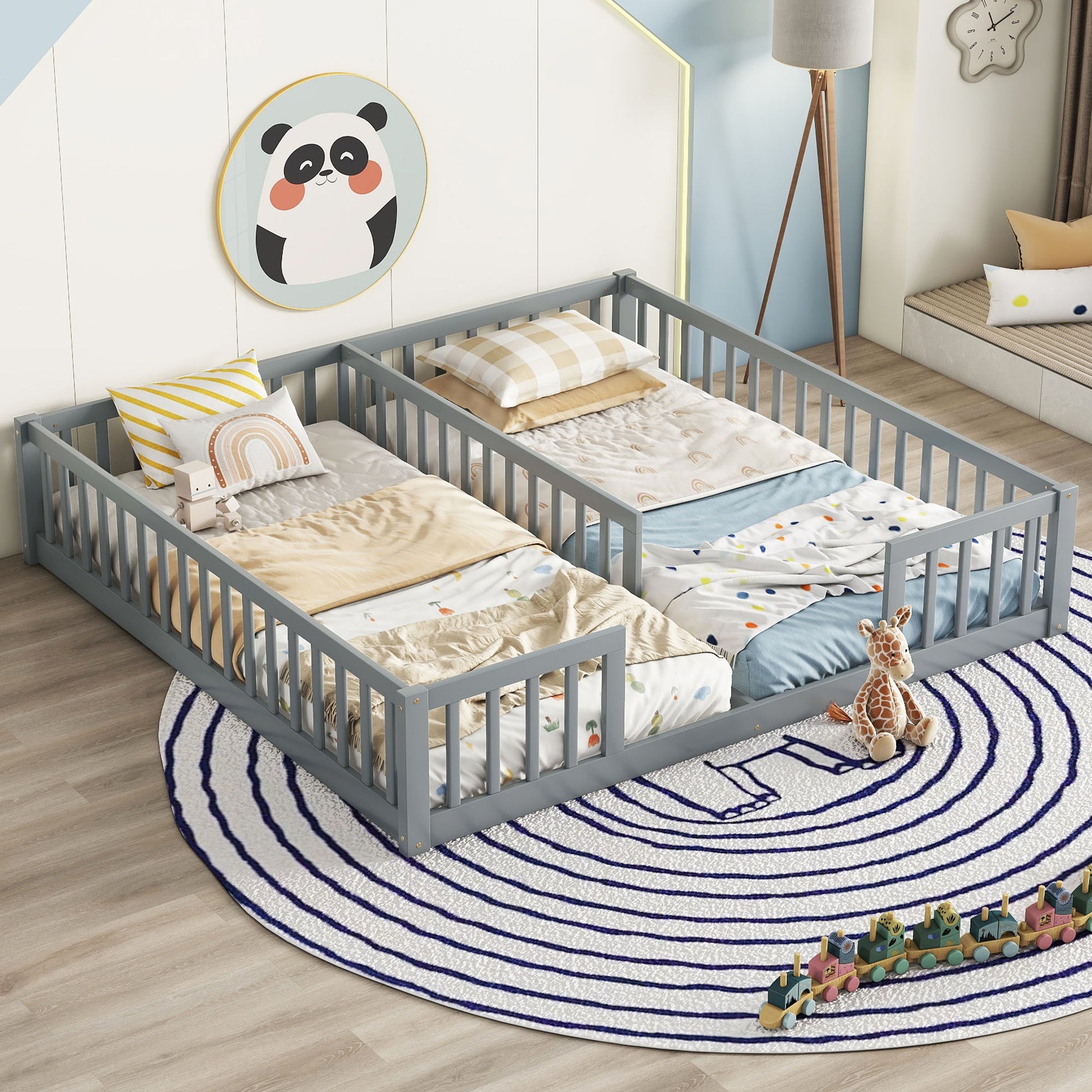 A children’s bedroom with a gray Double Floor Bed With Fence and guardrails (without door), pastel bedding, plush toys, a blue-and-white circular rug, panda wall art, and toy blocks scattered on the floor.