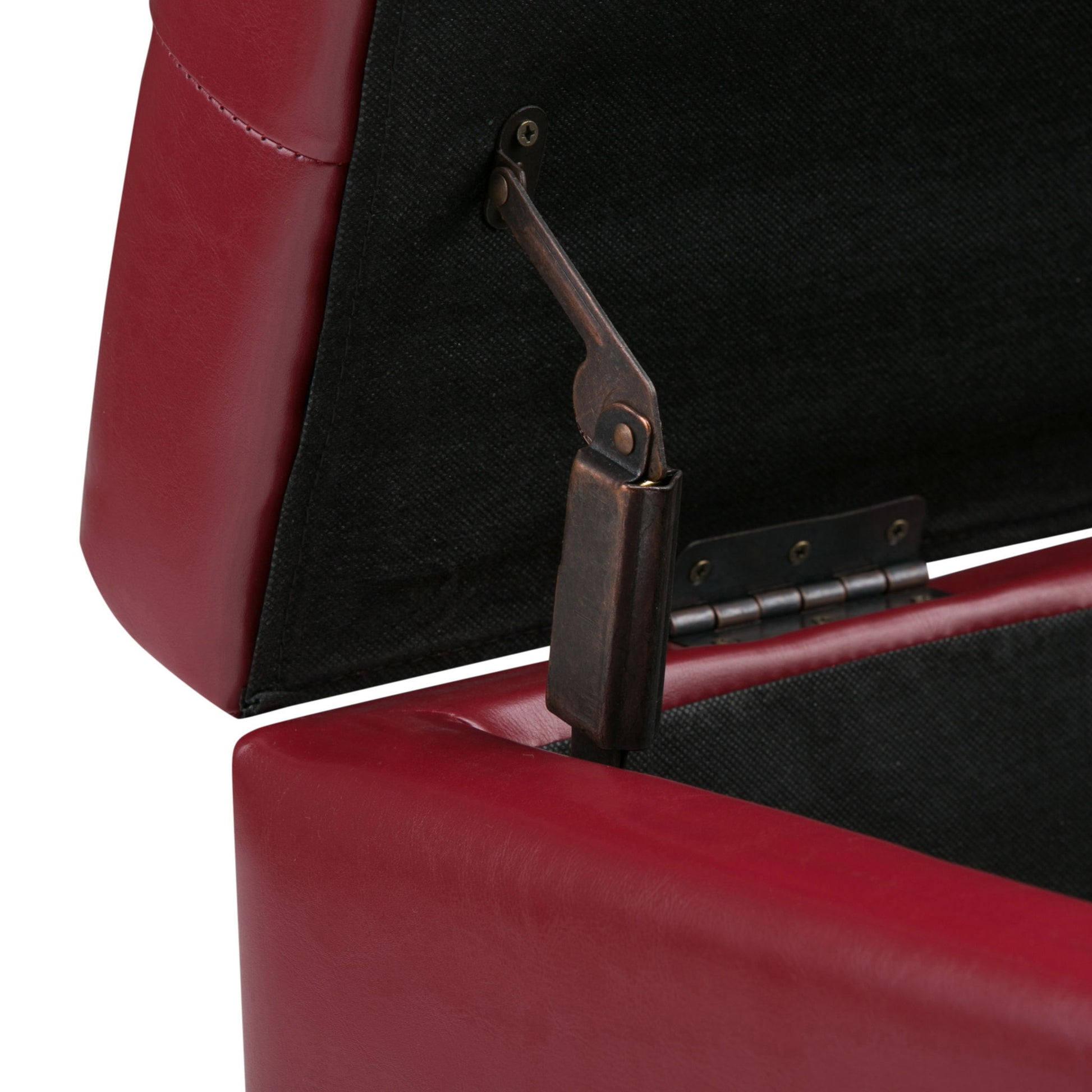Close-up of the Cosmopolitan - Upholstered Storage Ottoman in red, lid open to reveal a metal hinge and black interior lining.