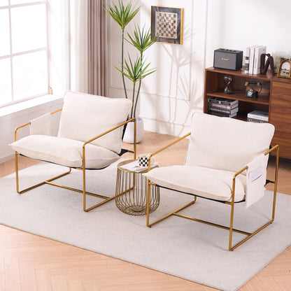Two Upholstered Hanging Armchairs with gold-plated metal frames, crushed foam cushions, and skin-friendly fabric sit on a rug by a small table with a chessboard, backed by a mid-century bookshelf and a tall plant near the window.