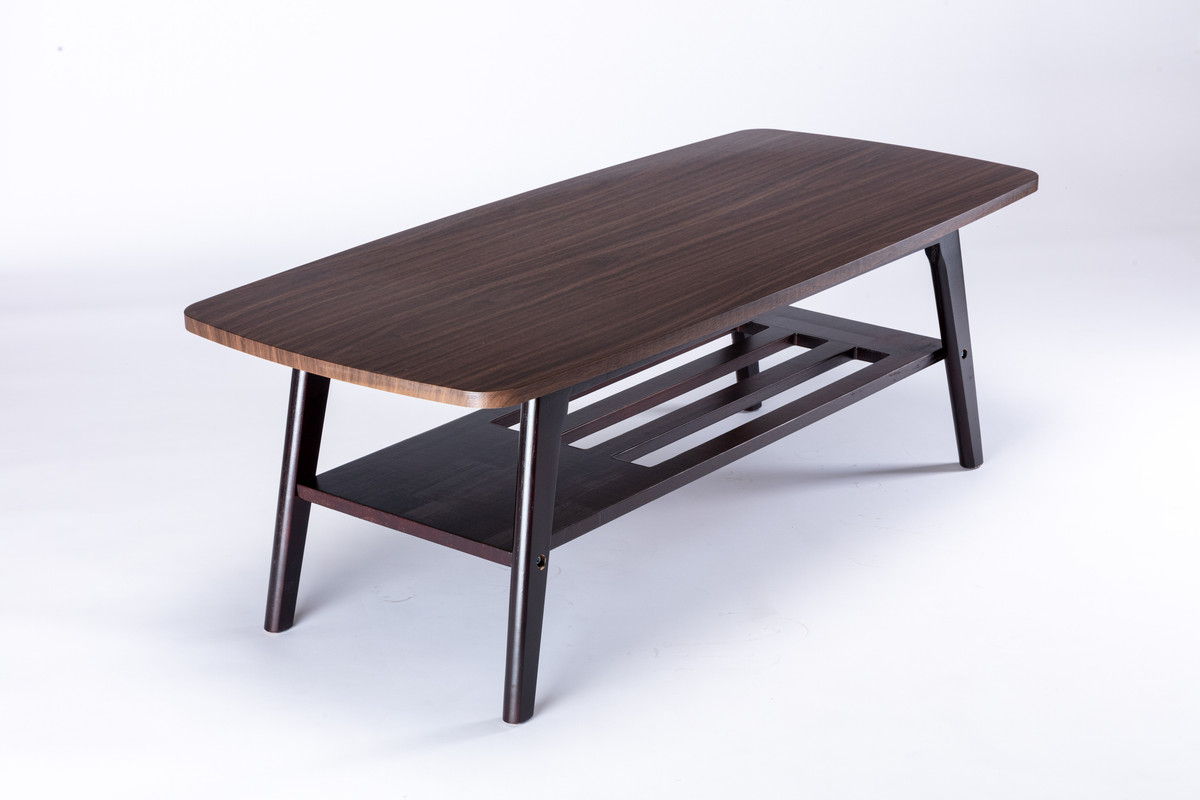 The Bahamas - Living Room Set features a rectangular wooden coffee table with rounded edges, angled legs, and a lower slatted shelf, shown on a white background.