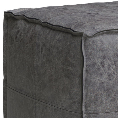 Close-up of the corner of the Brody - Versatile Square Pouf in dark gray distressed leather, showing visible seams and subtle wrinkles in the material.