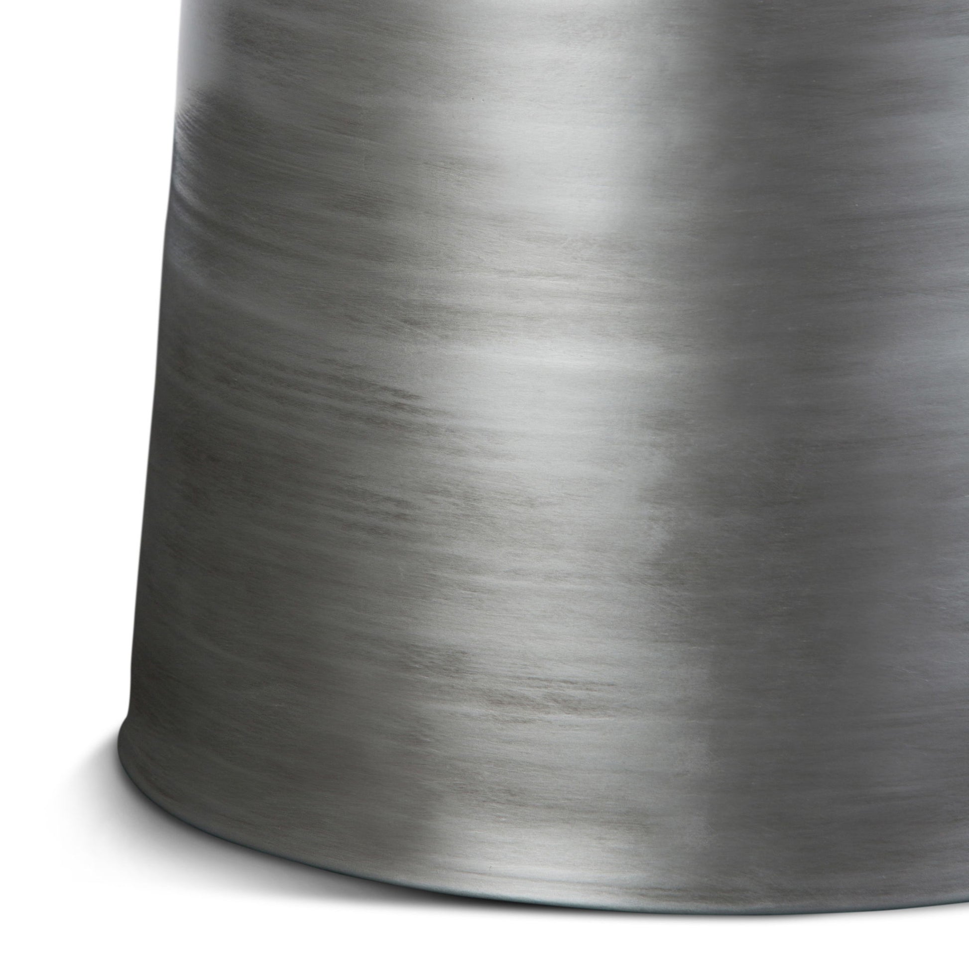The Toby - Handcrafted Metal Accent Table features a cylindrical brushed metal form with a smooth, slightly reflective surface and subtle horizontal streaks, displayed against a white background.