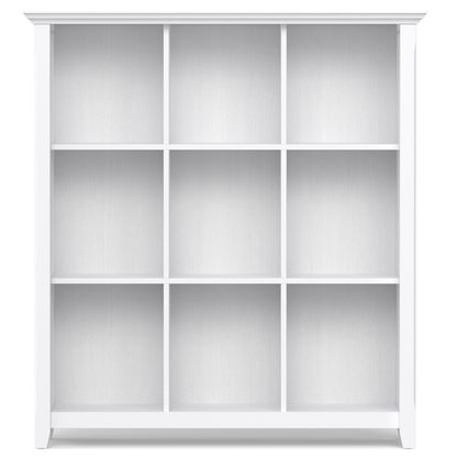 The Acadian - Handcrafted Cube Storage is a white bookshelf featuring a clean, modern design with three rows and three columns forming nine equal rectangular compartments against a plain background.