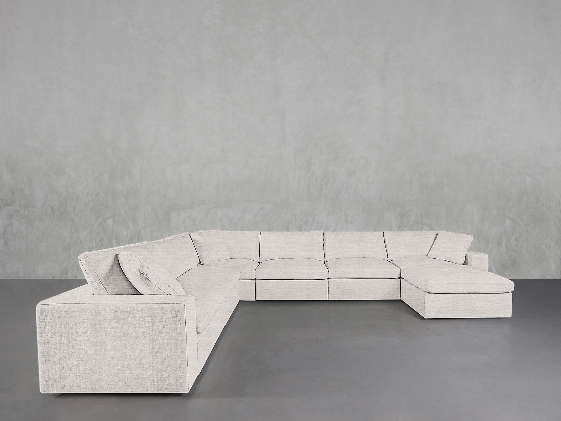 A spacious 7-Seat Modular Chaise Corner Sectional in light gray, featuring a right-side chaise, sits against a minimalist light gray wall and dark gray floor.