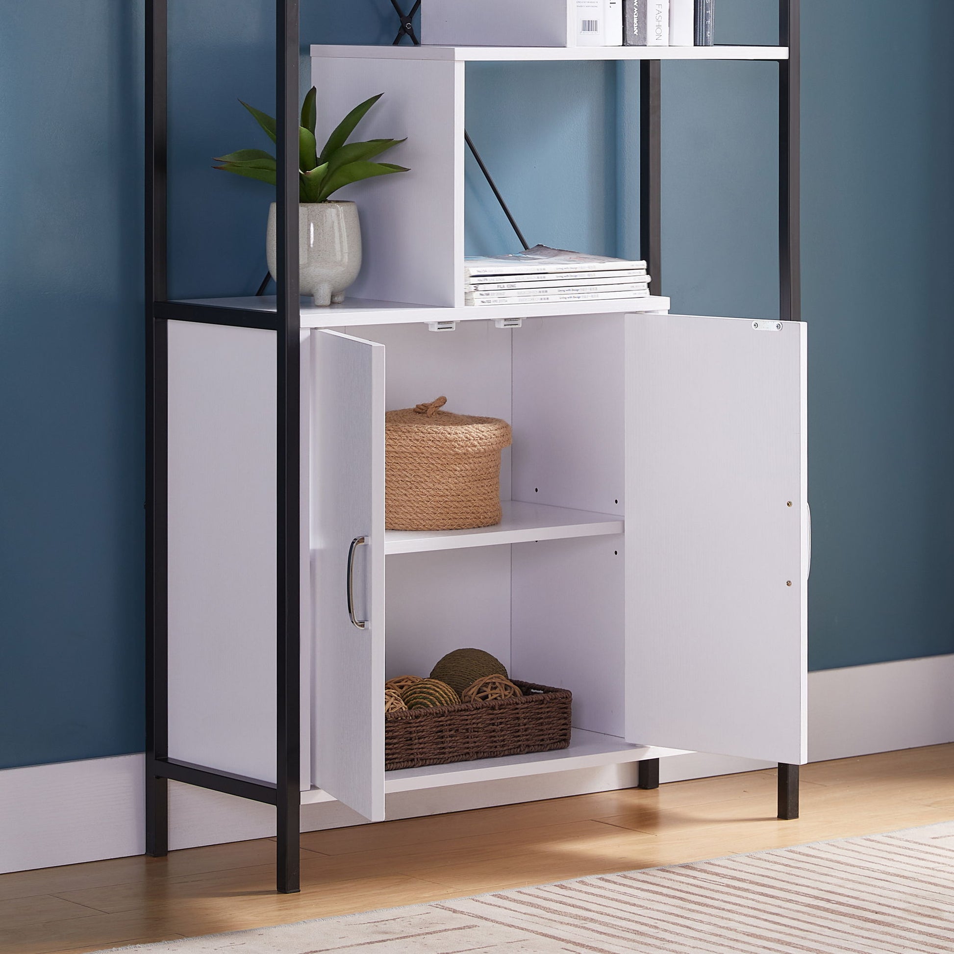 The Modern Bookcase With Two Door Storage Cabinet With Two Shelves features open doors revealing shelves with baskets of yarn, a potted plant, and books. The stylish piece stands out against a blue wall.