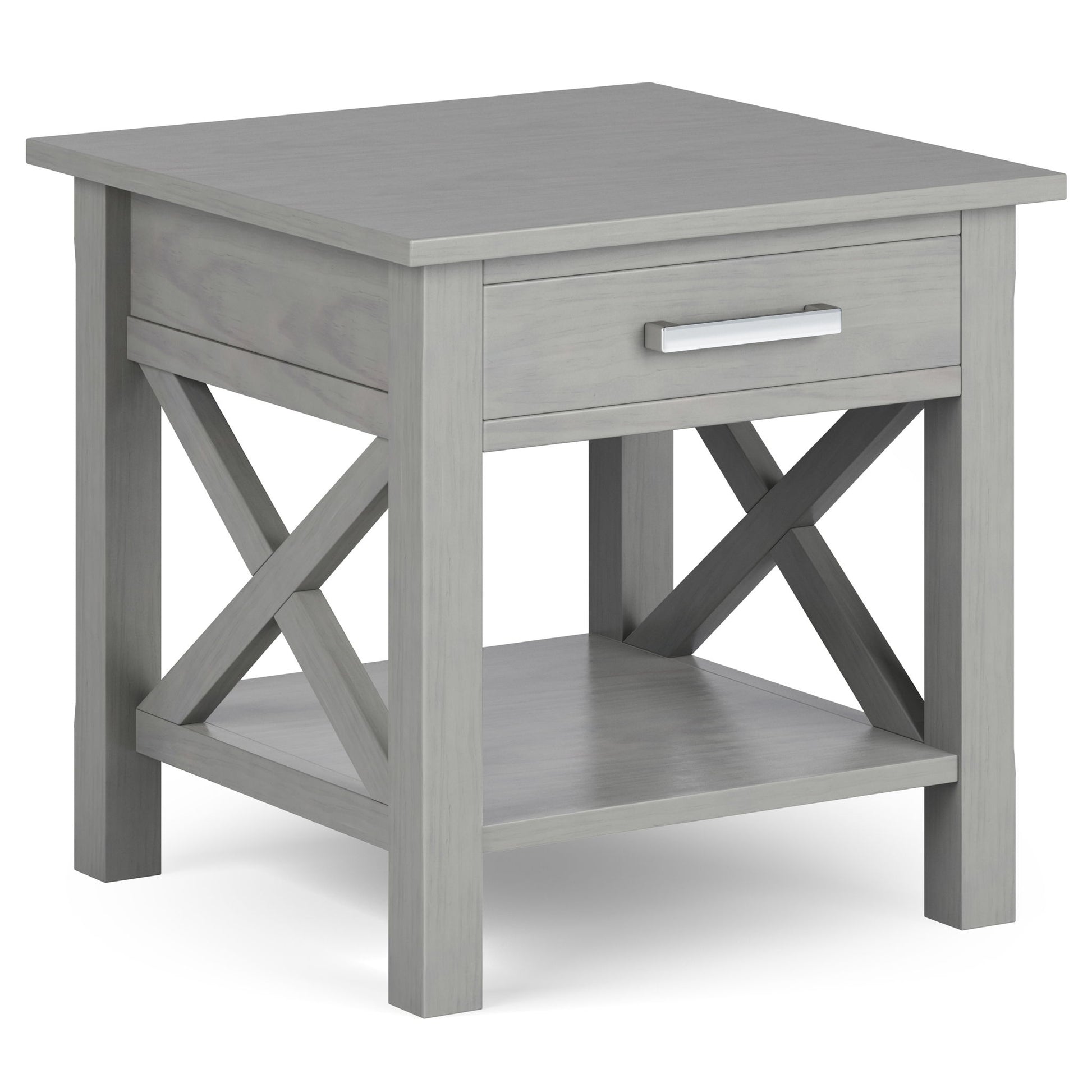 The Kitchener - Handcrafted Table is a gray wooden end table with a single drawer, metal handle, X-shaped side supports, and a lower open shelf.
