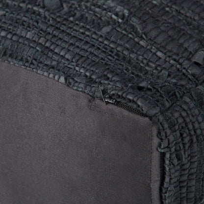 Close-up of the Fredrik - Handcrafted Square Pouf in black fabric, featuring a textured, woven corner, visible stitching, and a partially exposed zipper near the seam.