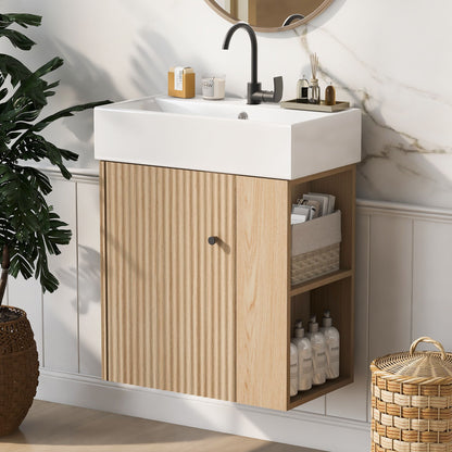 The Modern Floating Bathroom Vanity with ceramic basin features a white sink, black faucet, light wood cabinet with vertical grooves, open shelves for toiletries, a round mirror above, plus plants and baskets nearby—ideal for small bathrooms.