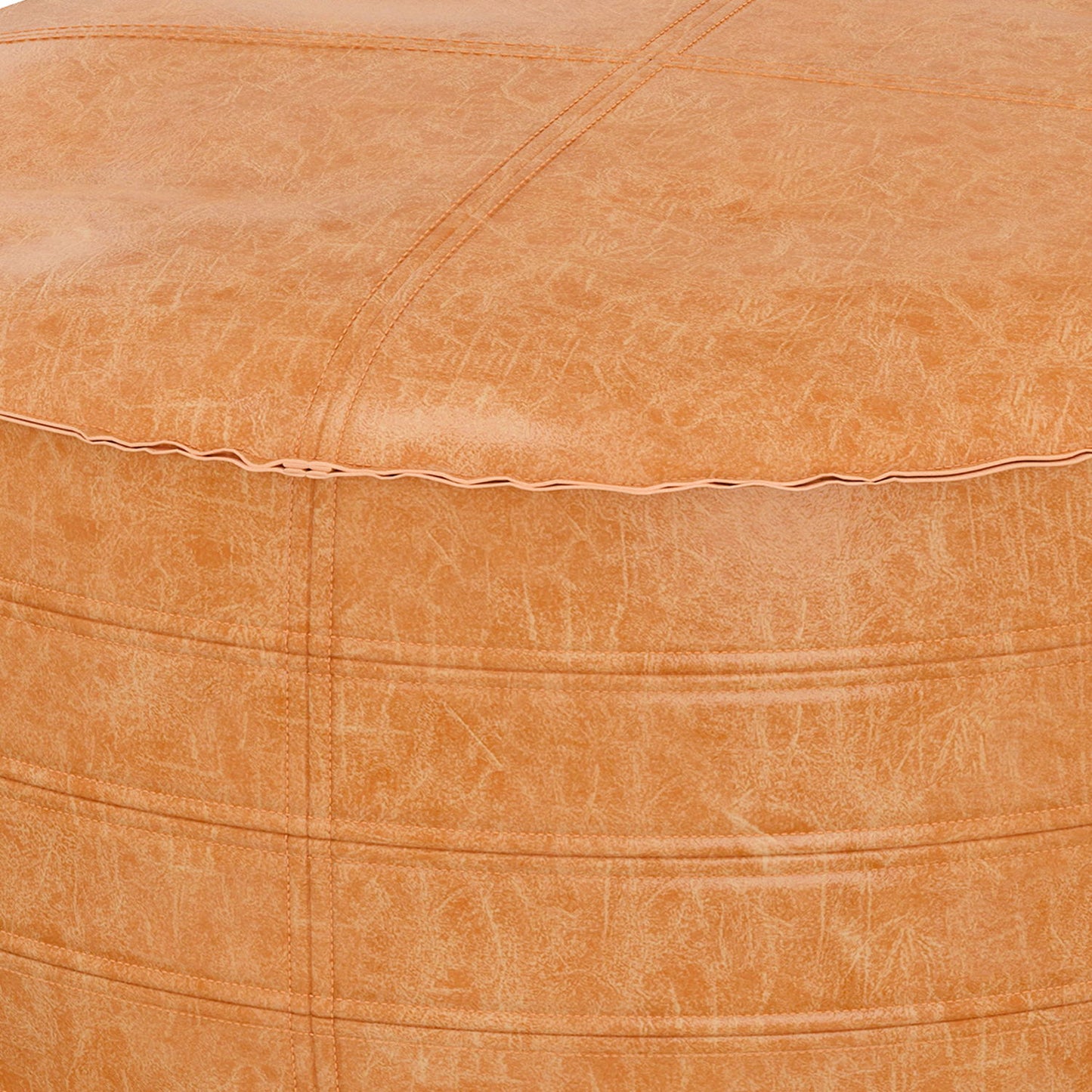 Close-up of the Brody - Round Pouf in tan faux leather shows visible stitching, a textured surface, and a subtle sheen on the material.