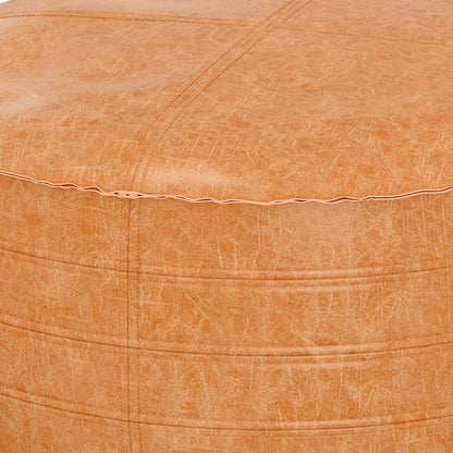 Close-up of the Brody - Round Pouf in tan faux leather shows visible stitching, a textured surface, and a subtle sheen on the material.