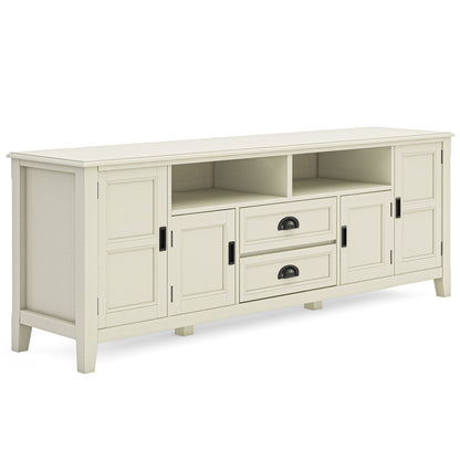 The Burlington TV Media Stand is a simple, modern white wooden stand featuring four cabinet doors, two central drawers with black handles, and an open shelf above the drawers. Clean lines complete its stylish design.