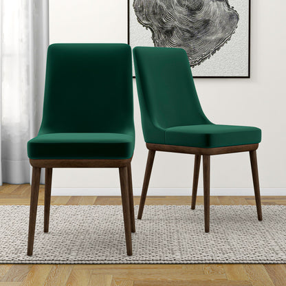 A set of two Kate Mid-Century Modern Dining Chairs are arranged on a textured beige rug in a bright room, with wooden floors, a curtain, and abstract black-and-white wall art in the background.