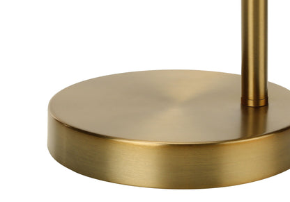 A close-up of the round, gold-colored metal base of the Lighting, Table Lamp, Contemporary - Gold shows its smooth, slightly reflective surface as the lamp pole extends vertically from it.