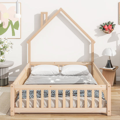 The room features a House-Shaped Headboard Floor Bed With Fence, dressed in white and gray bedding with two pillows and star patterns. Decor includes light walls, wall art, a small table with flowers, and a wreath.