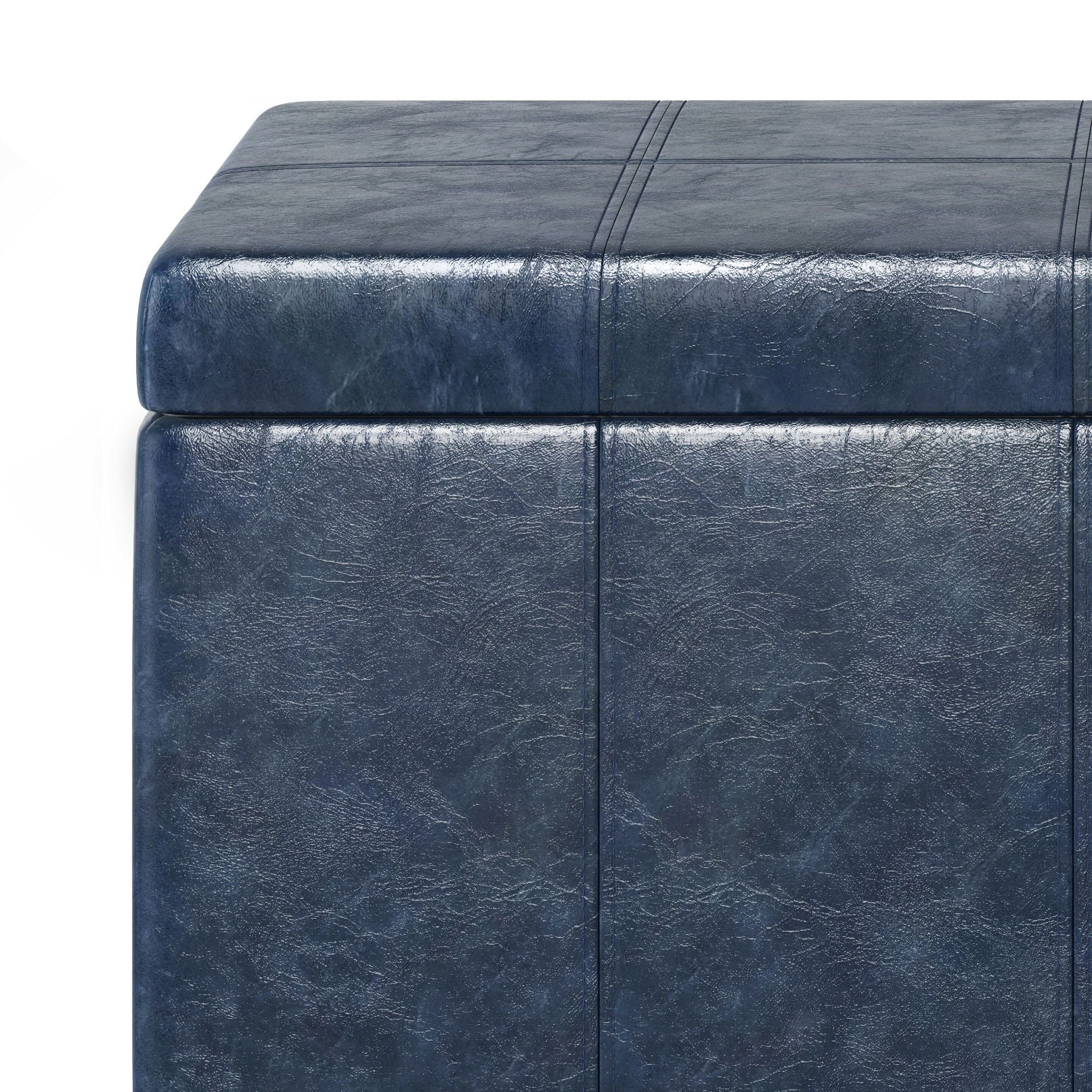 Close-up of the Dover Upholstered Storage Ottoman Bench in dark blue faux leather, featuring visible stitching and a textured surface. Image highlights the top and side corner against a white background.