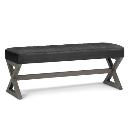 The Salinger - Large Upholstered Ottoman Bench features a black cushioned seat and wooden X-shaped legs in a simple, contemporary design.