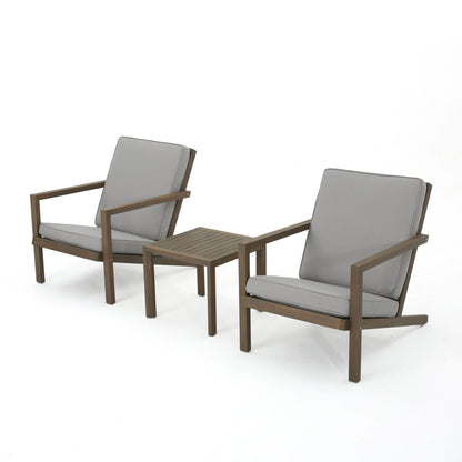 The Celestaria 3 Piece Outdoor Chat Set features two Adirondack chairs with light gray cushions and a matching side table, all arranged against a plain white background.