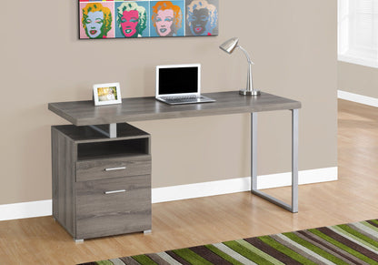 A Computer Desk For Home Office, Laptop, Left Right Set-Up with storage drawers sits against a beige wall with pop art above; a desk lamp and framed photo are on top. A striped rug is on the floor and a window is visible to the right.