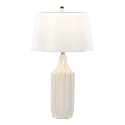 The Stella - Contemporary Table Lamp features a white, faceted ceramic base, a large round white fabric shade, and a silver finial on top for a sleek, minimalist look.