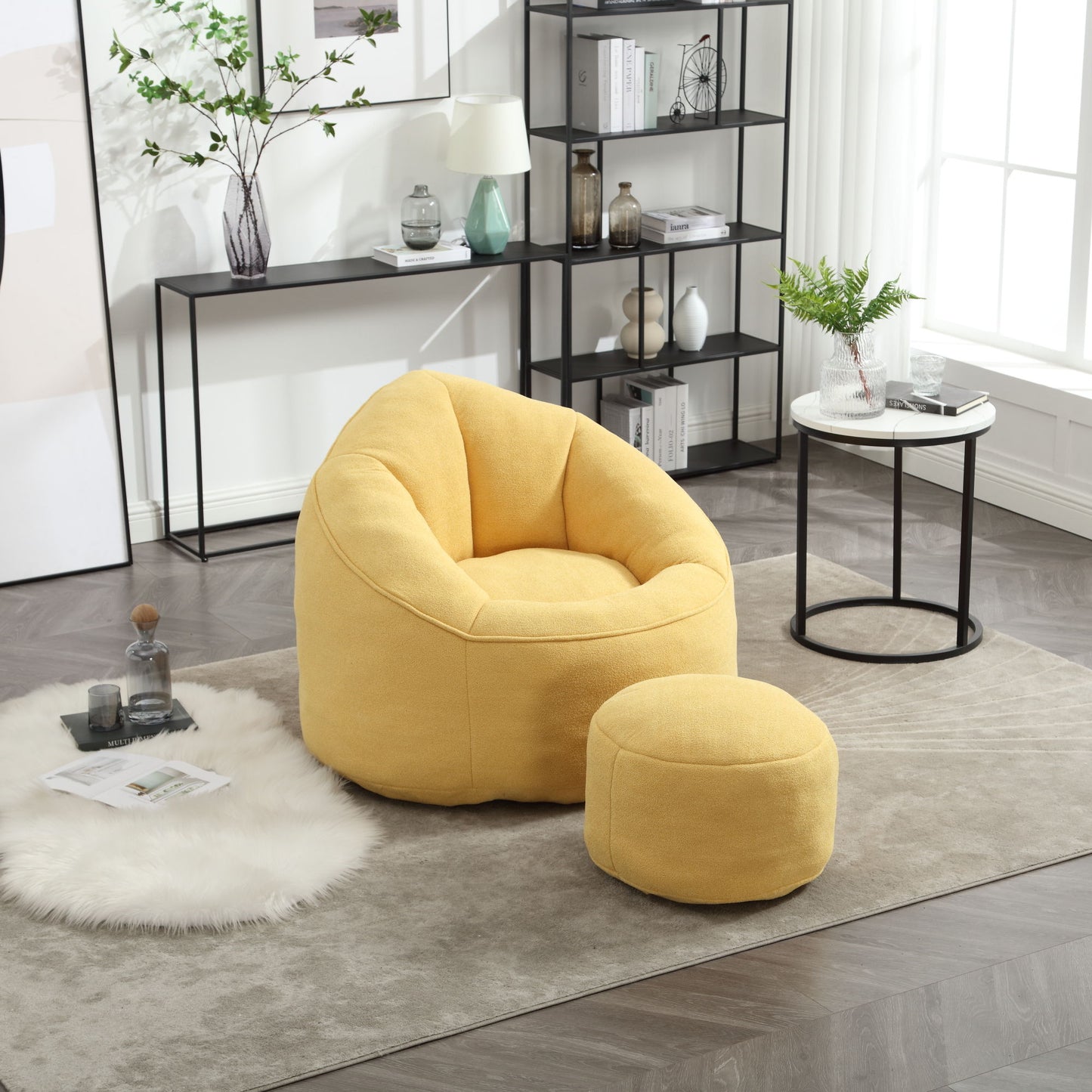 The Bedding Bean Bag Sofa Chair High Pressure Foam with Footrest, in yellow, sits on a beige rug in a modern living room next to a side table and black metal shelf, bathed in natural light from large windows.