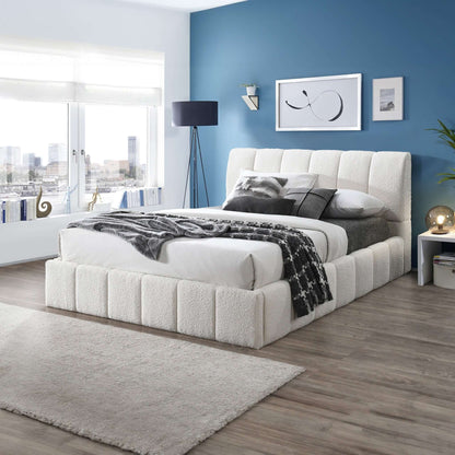 A modern bedroom features blue walls, a large window with city views, the Hilar Elegant Design Platform Bed in white with gray and white bedding, a nightstand, lamp, framed art, and a light gray rug over wood flooring.