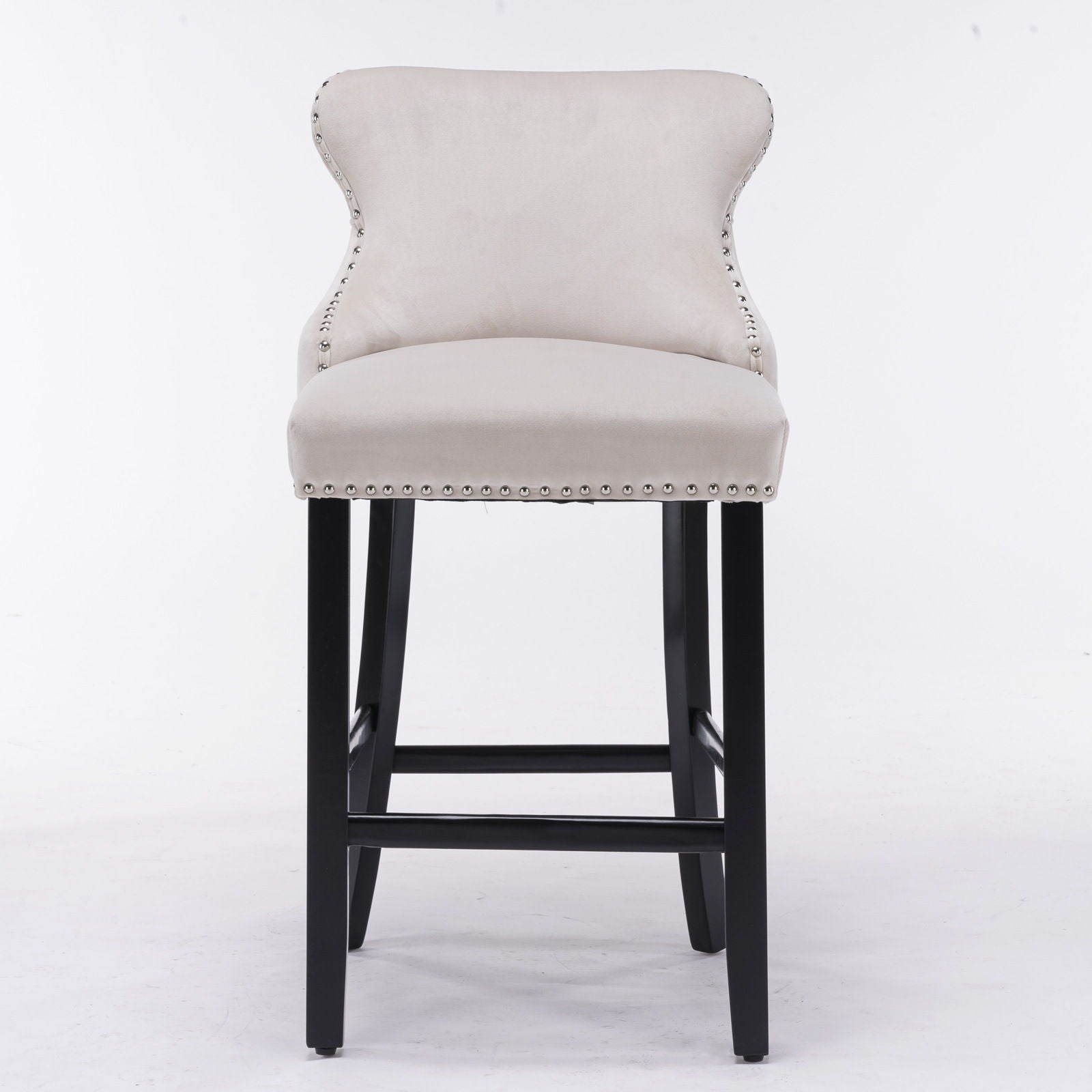 A set of 2 contemporary wing-back barstools with velvet upholstery, button tufting, chrome nailhead trim, and dark wooden legs shown on a white background.