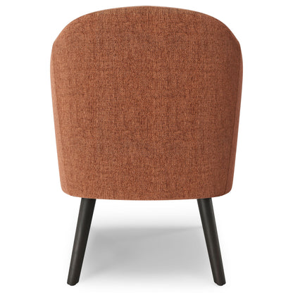 The Redding Upholstered Accent Chair features a rounded backrest in textured rust-colored fabric and four slightly angled dark wooden legs, shown from the back.