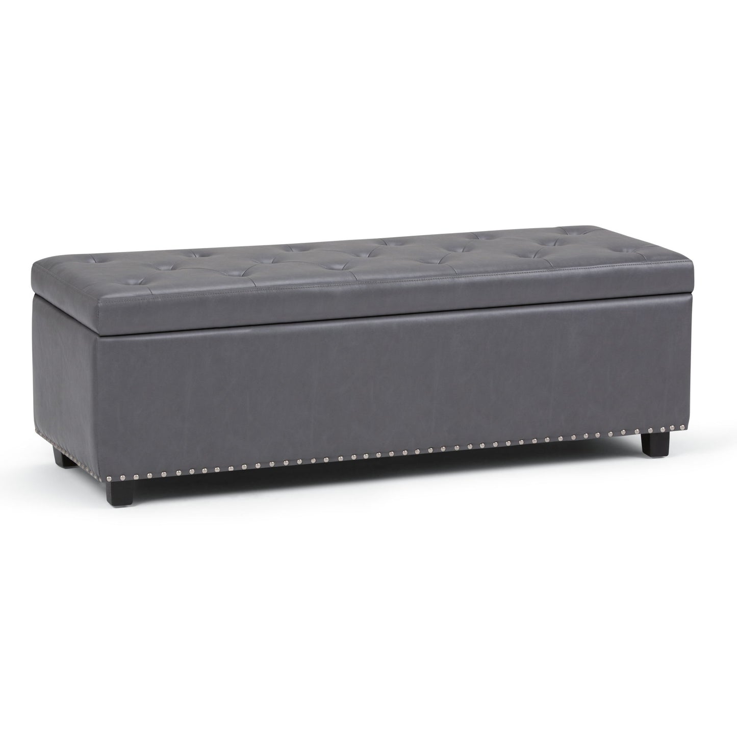 The Hamilton Upholstered Storage Ottoman features a rectangular, dark gray tufted design with short black legs and silver nailhead trim along the base, offering stylish storage for any space.
