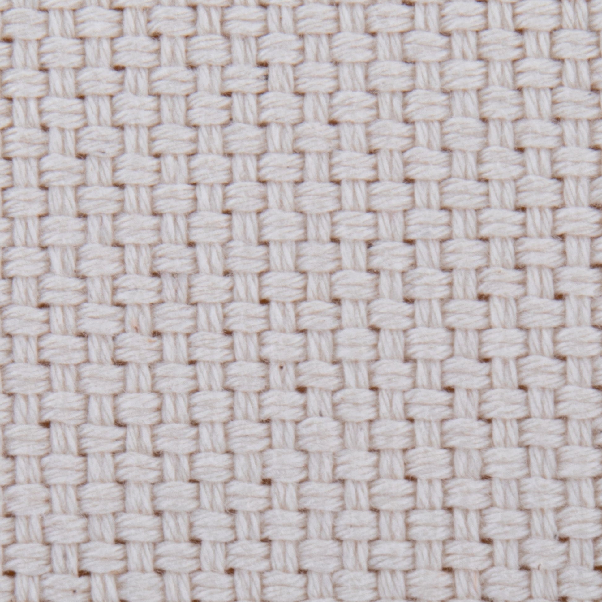 Close-up of the Large Round Pouf - Knitted Beige, featuring thick, tightly interlaced threads in a basket weave pattern. The textured surface has small, evenly spaced square holes for a distinct grid-like look.
