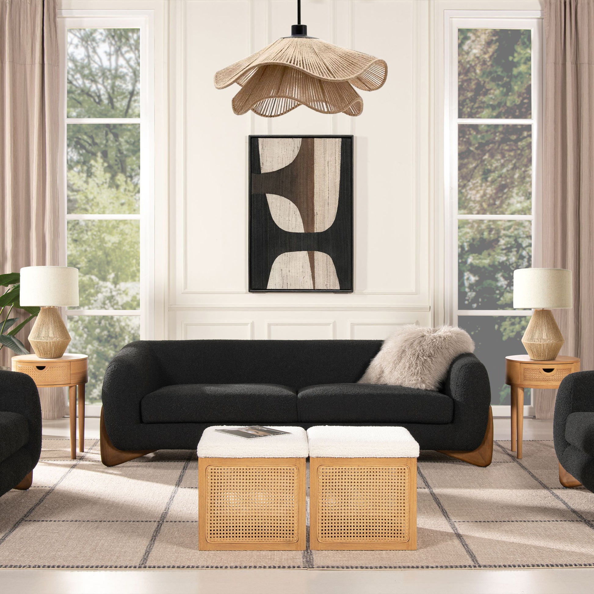 Modern living room featuring the Alpine - Luxurious Upholstery Sherpa Sofa, wooden side tables with lamps, two wicker ottomans, abstract wall art, and large windows with beige curtains. A woven pendant light adds a stylish touch.