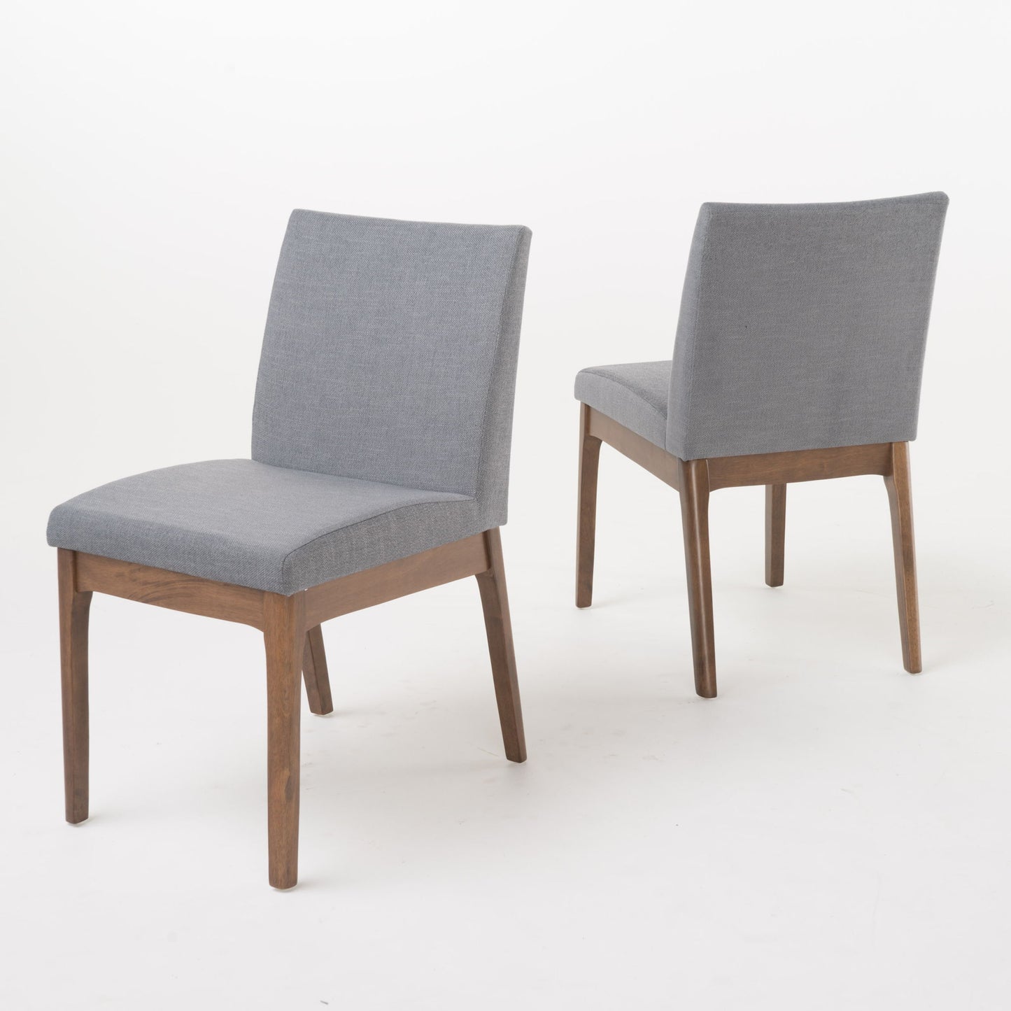 The Contemporary Fabric Comfort Dining Chairs (Set of 2) feature light gray upholstered seats and backs with wooden legs and frames, shown on a plain white background with one chair facing forward and the other angled away.