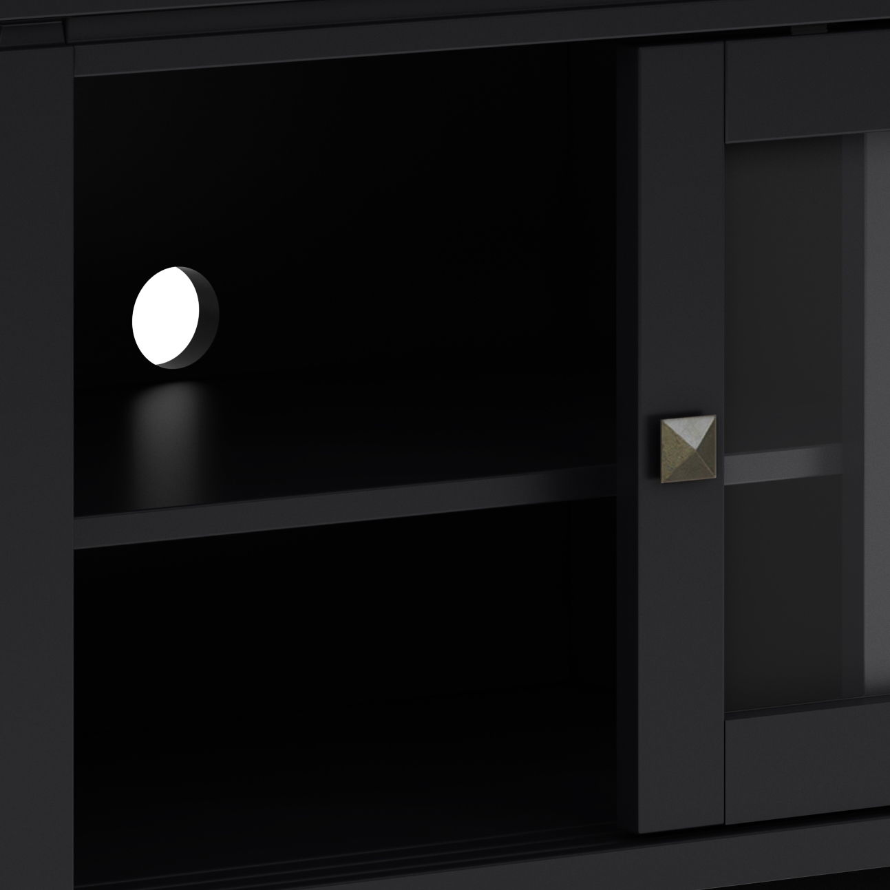 Close-up of the Cosmopolitan - Handcrafted TV Media Stand in black, featuring a shelf, round white cable hole on the back panel, metallic square knob on the door, and a frosted glass panel on the right.