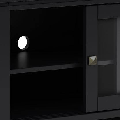 Close-up of the Cosmopolitan - Handcrafted TV Media Stand in black, featuring a shelf, round white cable hole on the back panel, metallic square knob on the door, and a frosted glass panel on the right.