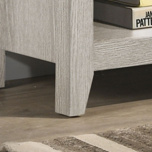 A close-up of the Benito TV Stand in light gray wood shows the corner detail and stacked books on the lower shelf, with wood or laminate flooring underneath.