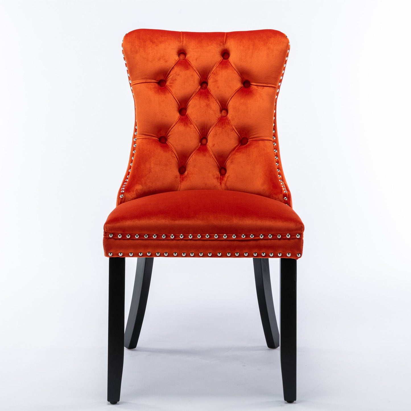 Front view of the Nikki modern velvet upholstered dining chair with orange tufted seat, nailhead trim, and black wooden legs, showcased against a white background (set of 2).
