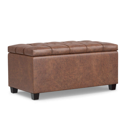 The Sienna Upholstered Storage Ottoman Bench features a brown, leather-like finish, cushioned tufted lid, rectangular shape, and short black legs for stylish storage and seating.
