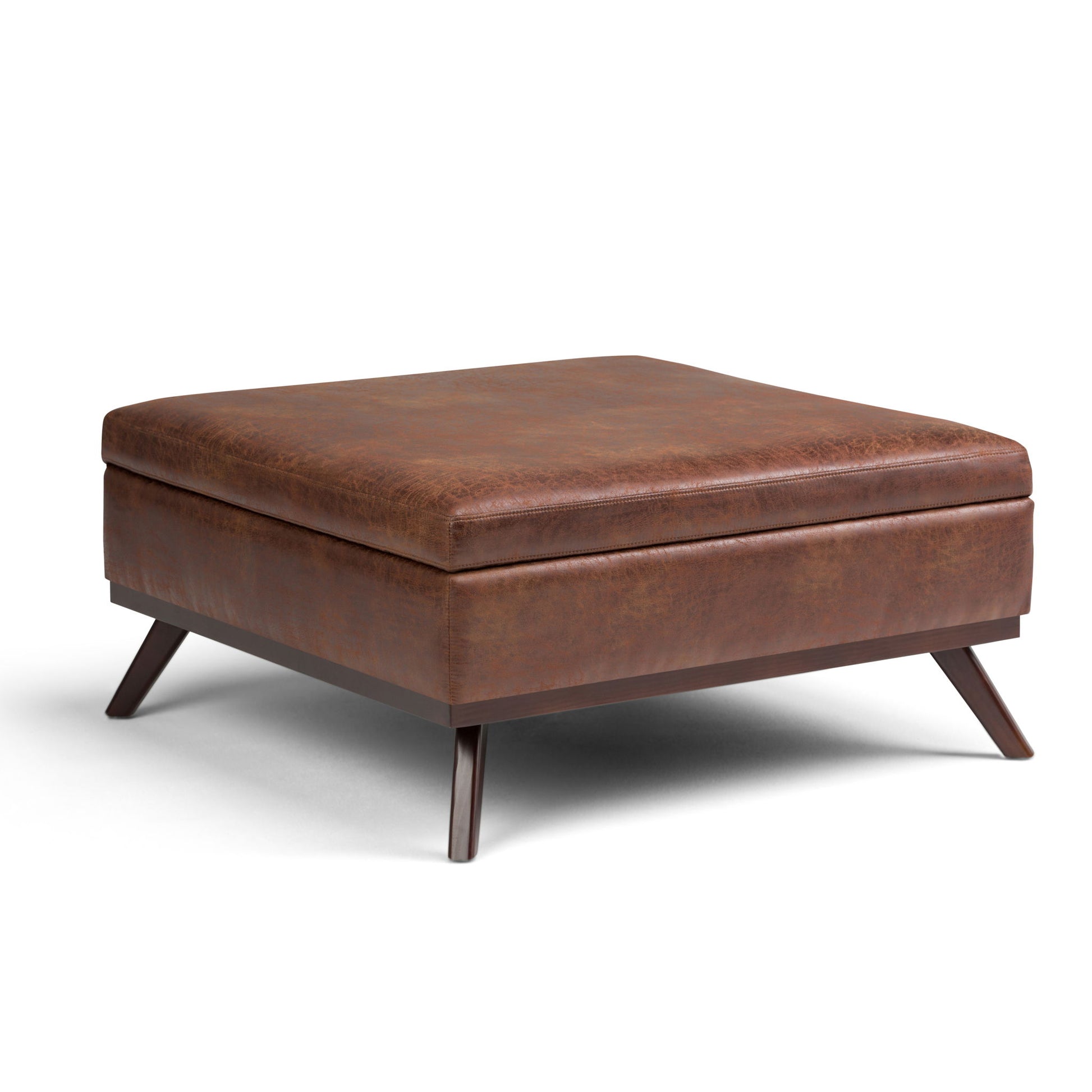 The Owen is a multifunctional square coffee table storage ottoman with mid-century modern design, featuring brown leather upholstery and angled dark wooden legs.