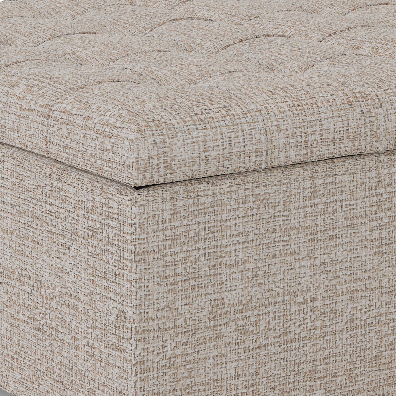 Close-up of the corner of the Harrison - Upholstered Coffee Table Storage Ottoman, featuring a beige and brown textured finish with a tufted, cushioned top and square, upholstered base.