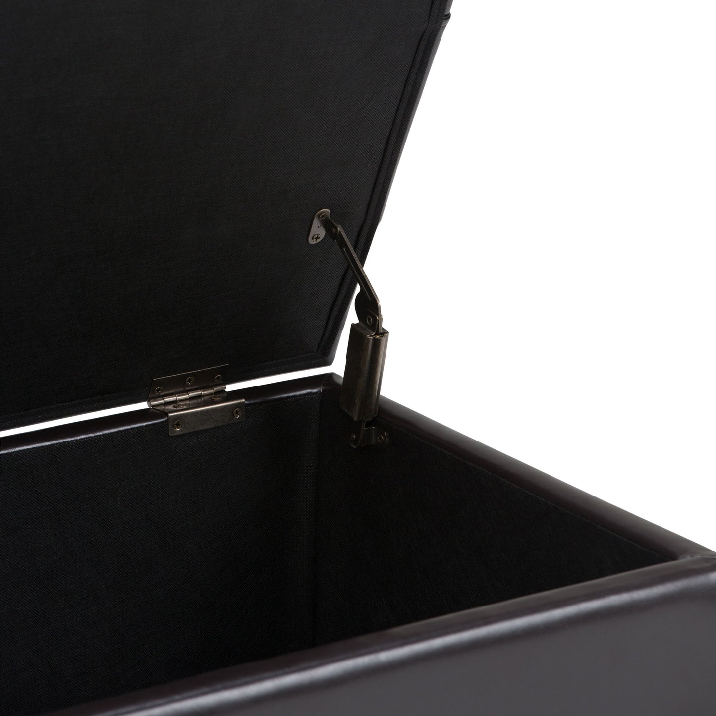 A close-up of the Sienna - Upholstered Storage Ottoman Bench showcases its inside corner, hinge, and lid support mechanism against a white background.