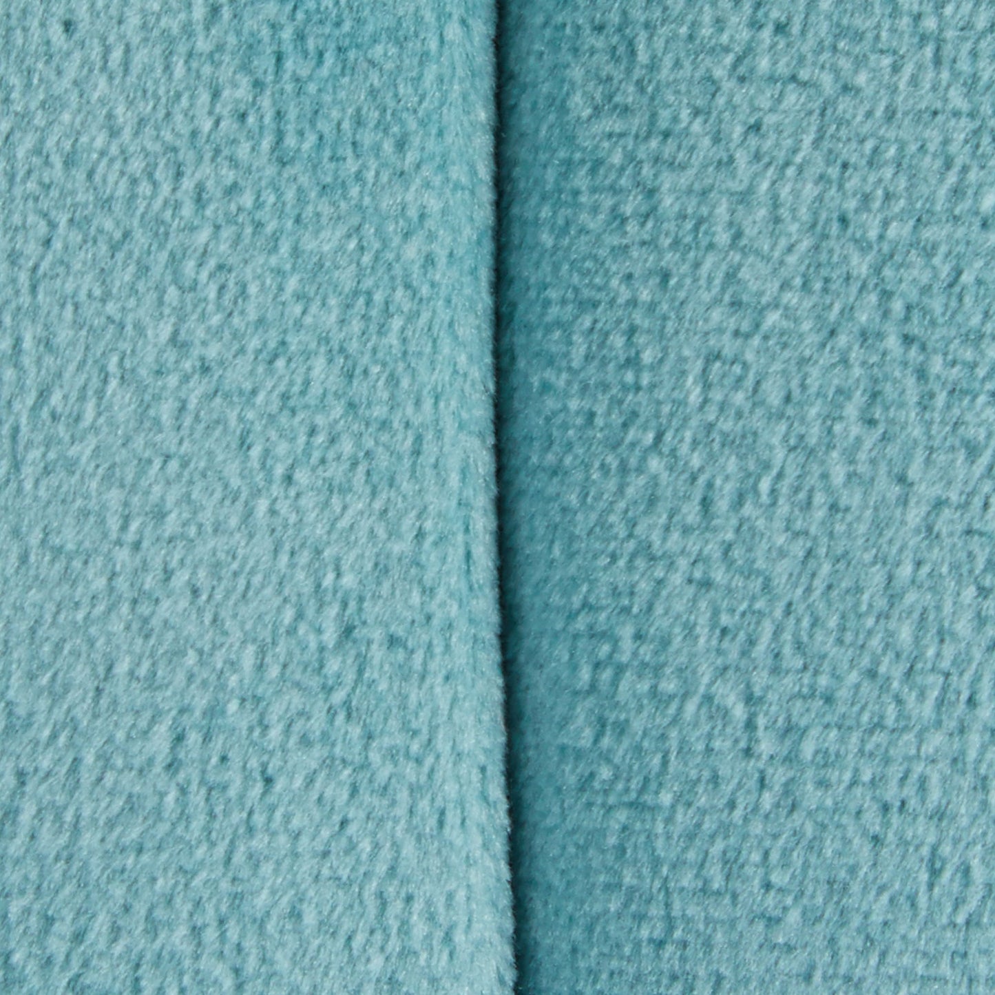 Close-up of the Braided - Versatile Round Ottoman in light blue, showing its textured fabric and a vertical seam down the center.