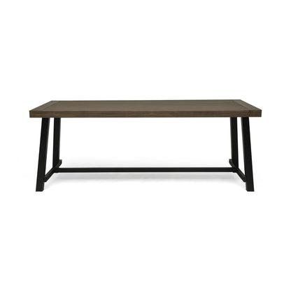 A modern, minimalist outdoor dining table featuring a gray top and rustic metal legs, shown against a white background.