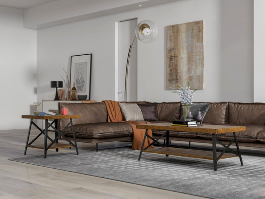 A modern living room with a brown leather sectional sofa, wooden coffee table, the Douglas End Table, a gray patterned rug, minimalist wall art, a floor lamp, and decorative accessories on the tables.