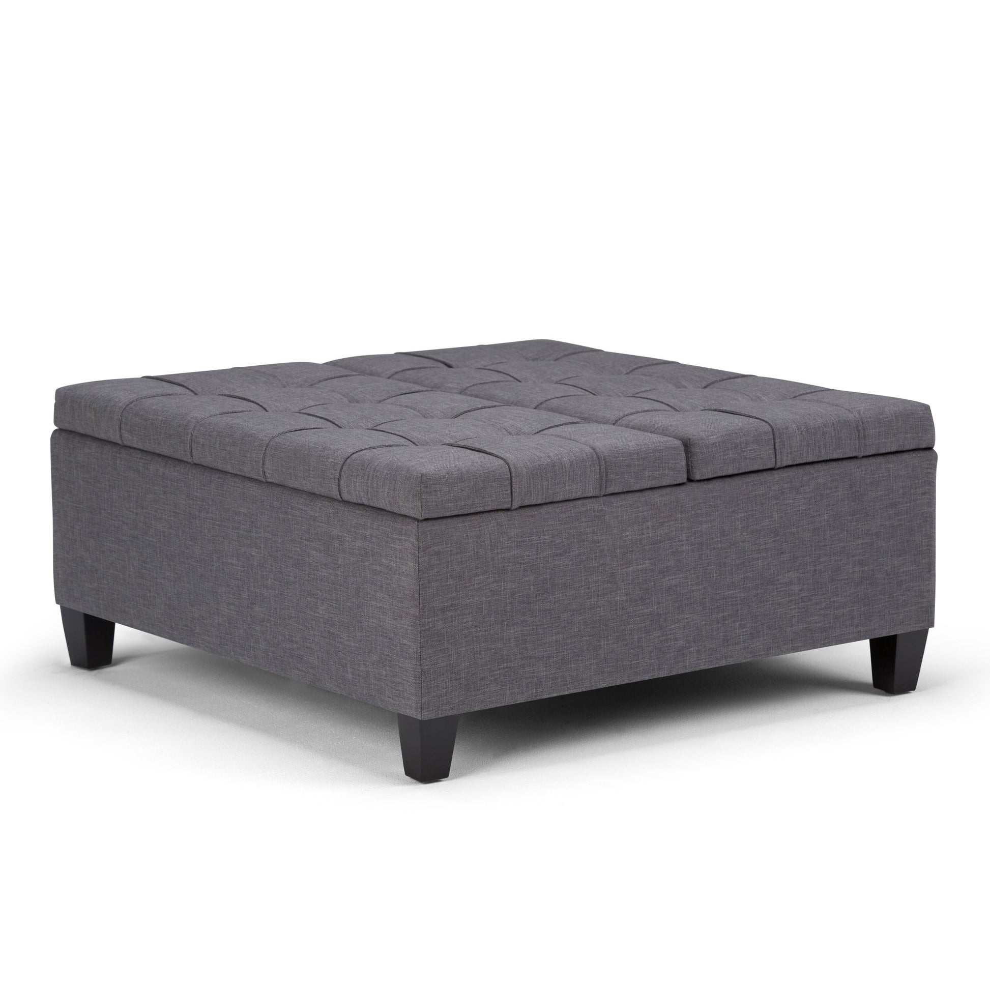 The Harrison Upholstered Coffee Table Storage Ottoman features a square design in dark gray fabric with tufted top details and short black legs, shown against a plain white background.