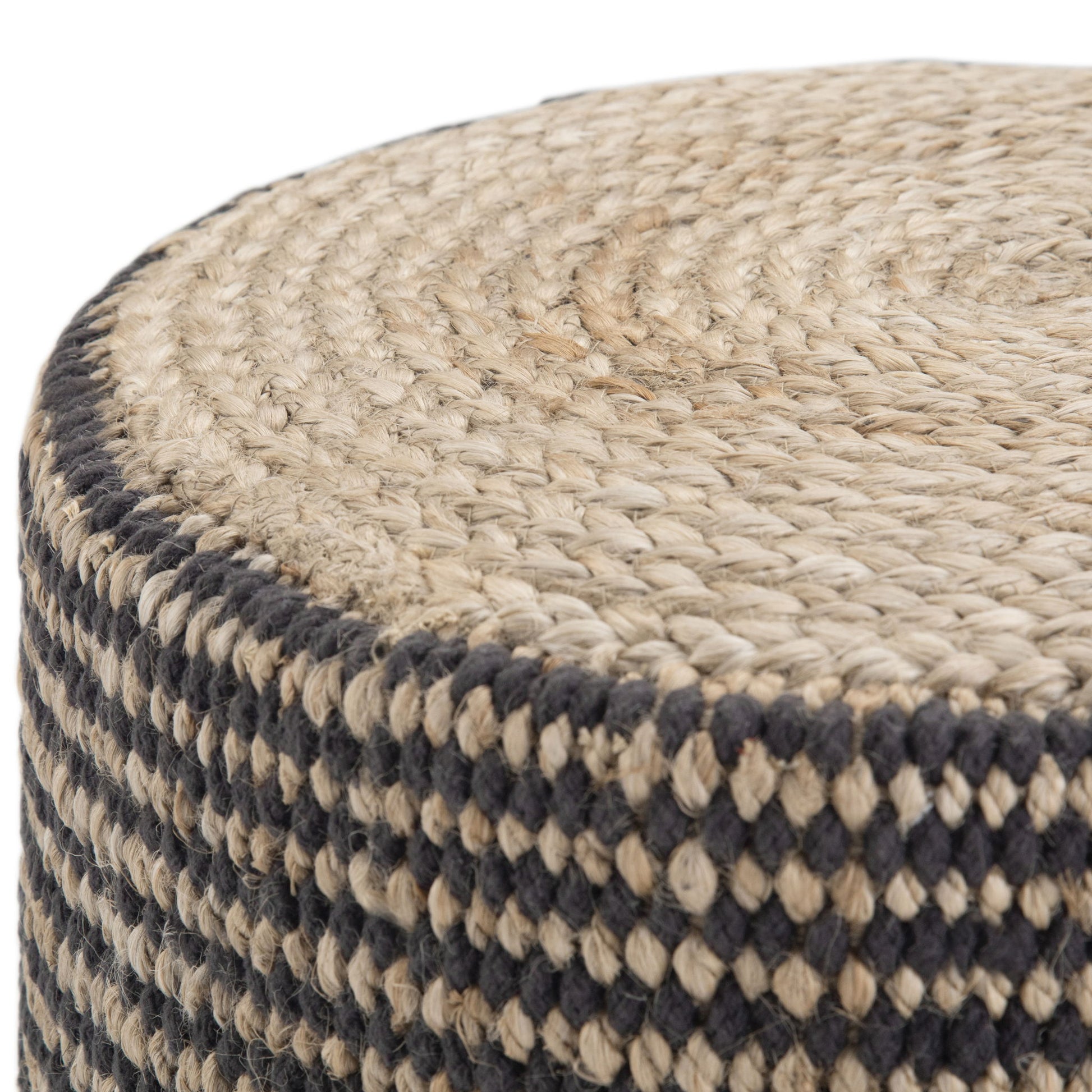 Close-up of the Larissa - Handcrafted Round Braided Pouf, featuring a coiled top and black and natural checkered sides, crafted from woven jute.