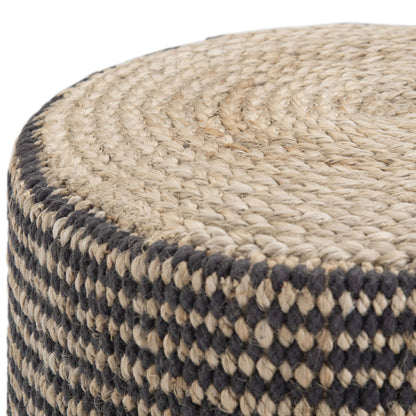 Close-up of the Larissa - Handcrafted Round Braided Pouf, featuring a coiled top and black and natural checkered sides, crafted from woven jute.