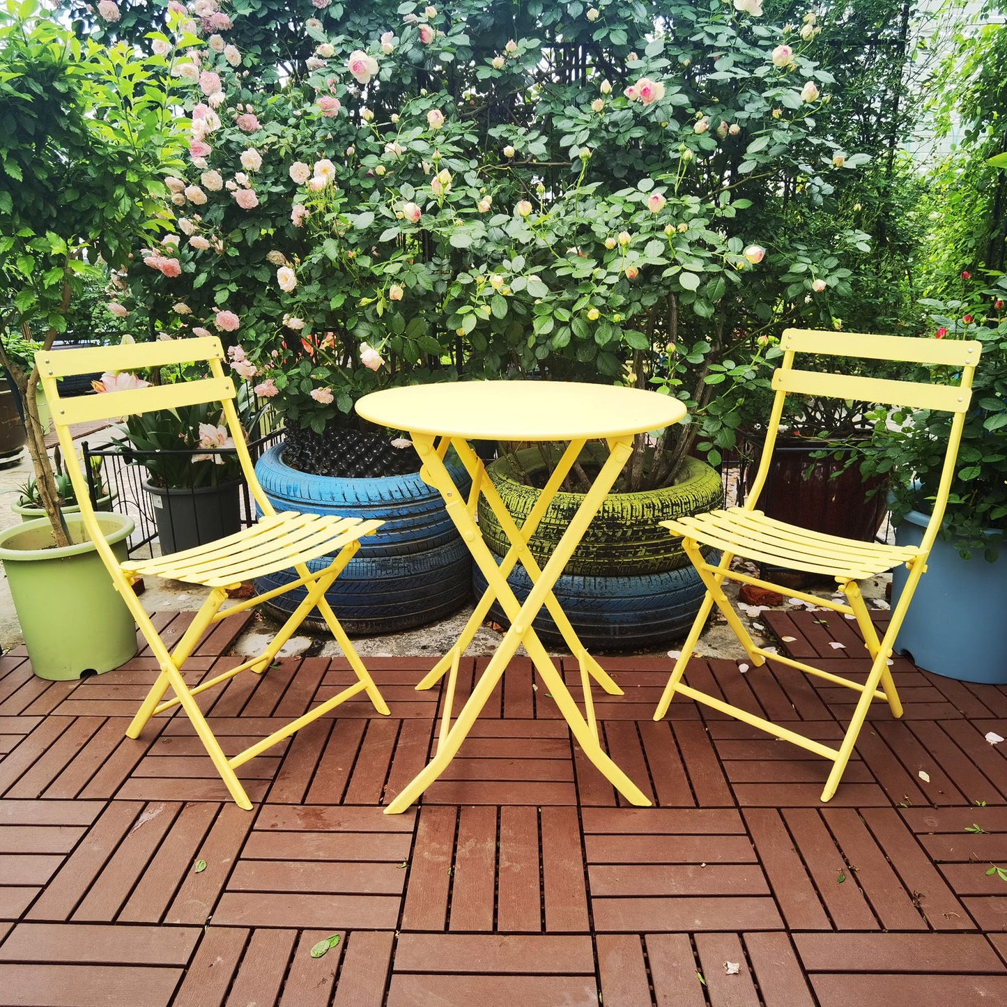 A 3 Piece Patio Bistro Set featuring a foldable round table and chairs on a patio.