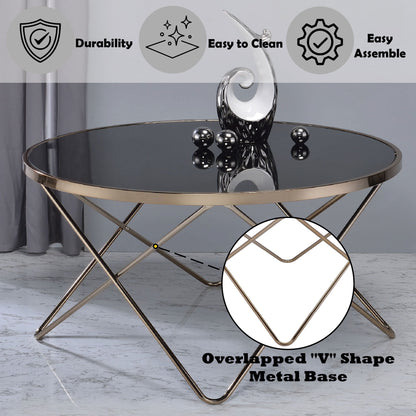 The Valora - Glass Coffee Table features a round glass top and a striking metallic gold base with overlapping "V" shapes. Comes with decorative sculpture and orbs, and icons for durability, easy cleaning, and simple assembly.
