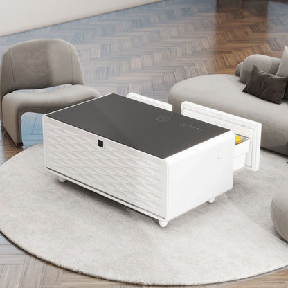 A Modern Smart Coffee Table With Built-In Fridge, Bluetooth speaker, wireless charging, and touch control panel sits on a round rug between a gray armchair and a curved sectional sofa atop a wooden floor.